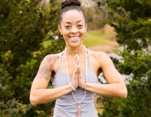 Portrait of Desireé Melonas in a yoga pose